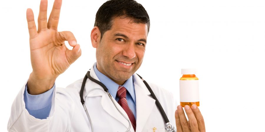 male-doctor-holding-pill-bottle-with-blank-label-gesturing-okay-picture-id173593466