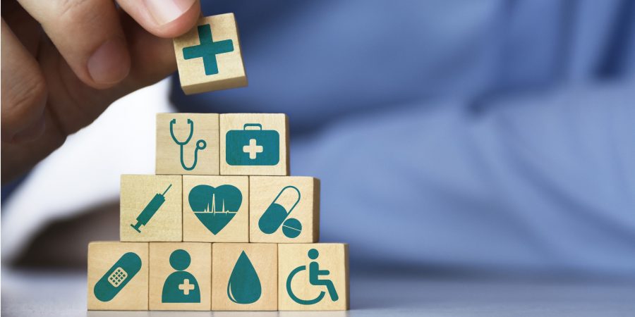 medical-health-insurance-concept-mens-hand-arranging-wood-blocks-with-picture-id1305053558